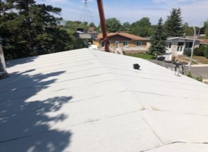 A white roof with a chimney on top of it