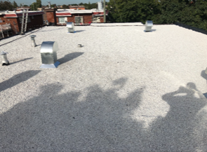 A white roof with a shadow of a person on it