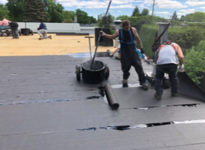 A group of people are working on a roof.