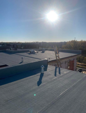 The sun is shining brightly on the roof of a building