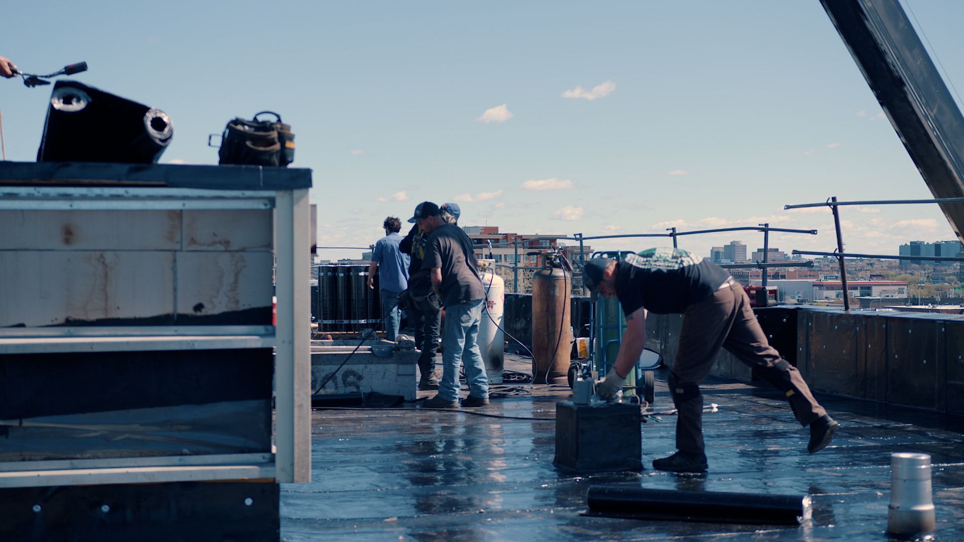 A group of men are working on a roof.