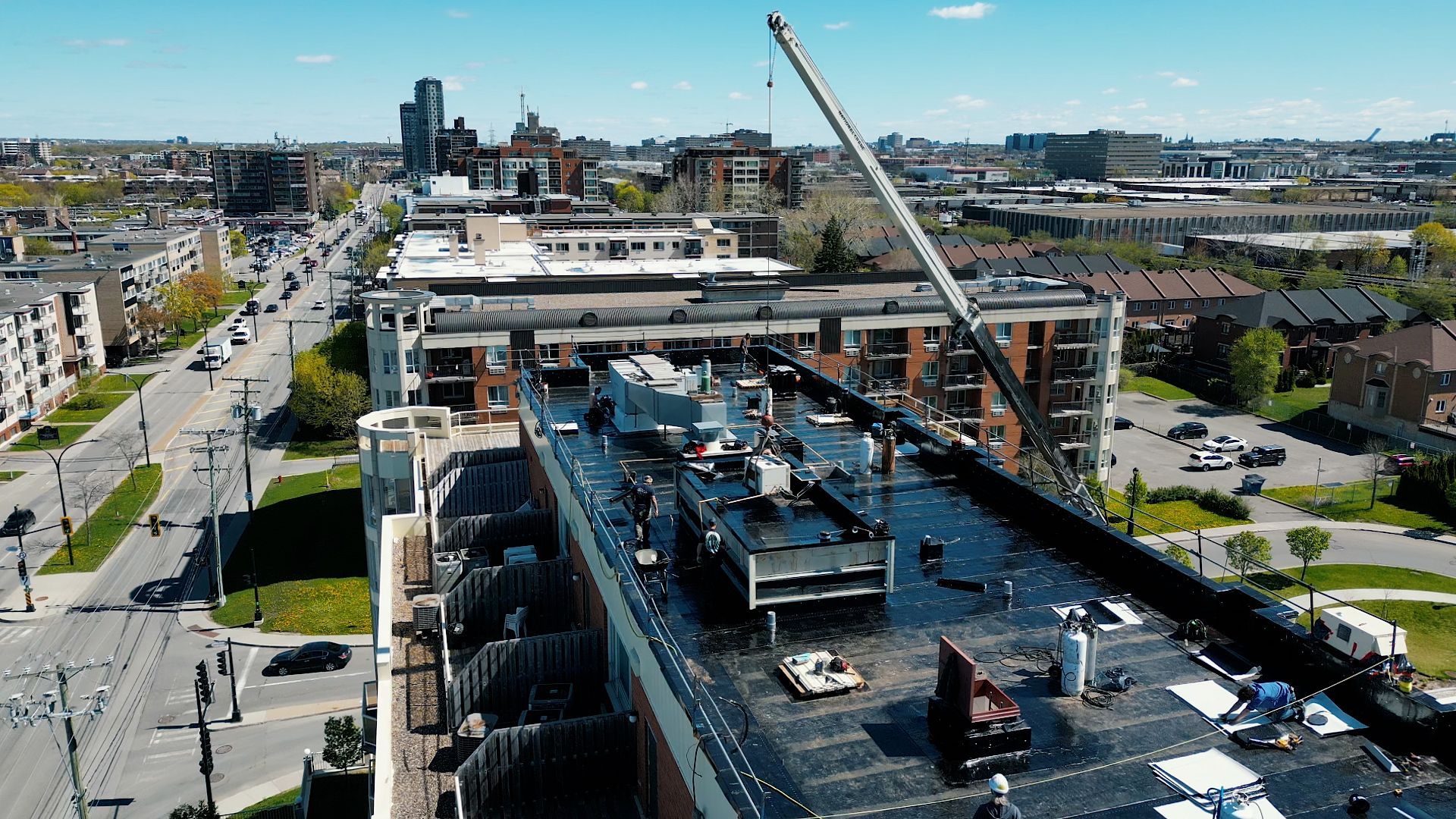 An aerial view of a large building with a crane on top of it.