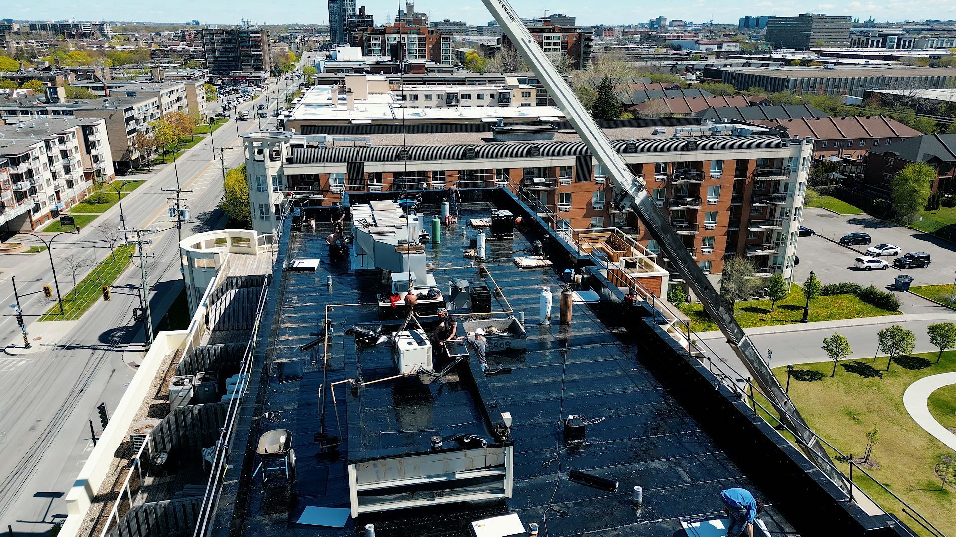 An aerial view of a building under construction with a crane on top of it.
