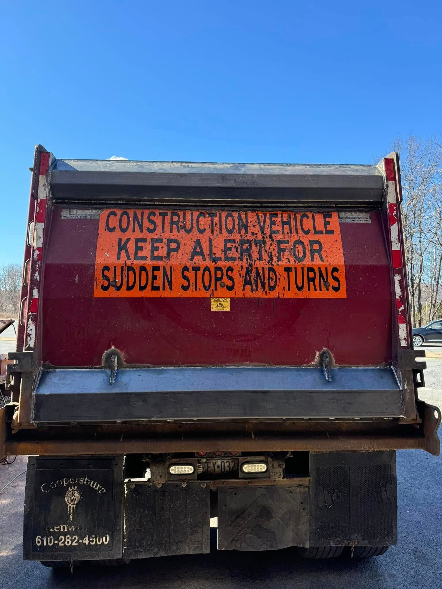 Back of a construction truck with orange sign: 