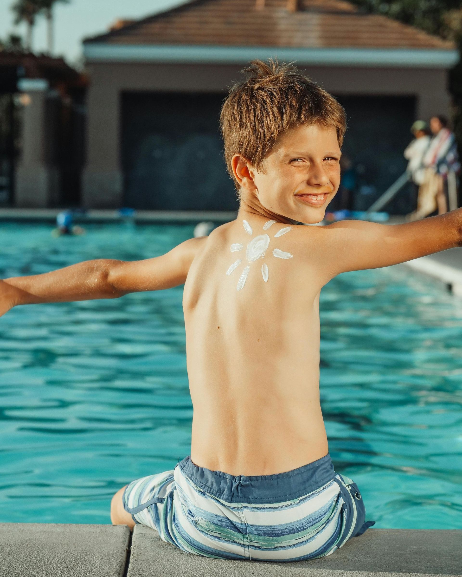 Smiling boy on edge of swimming pool in Hampton Roads VA