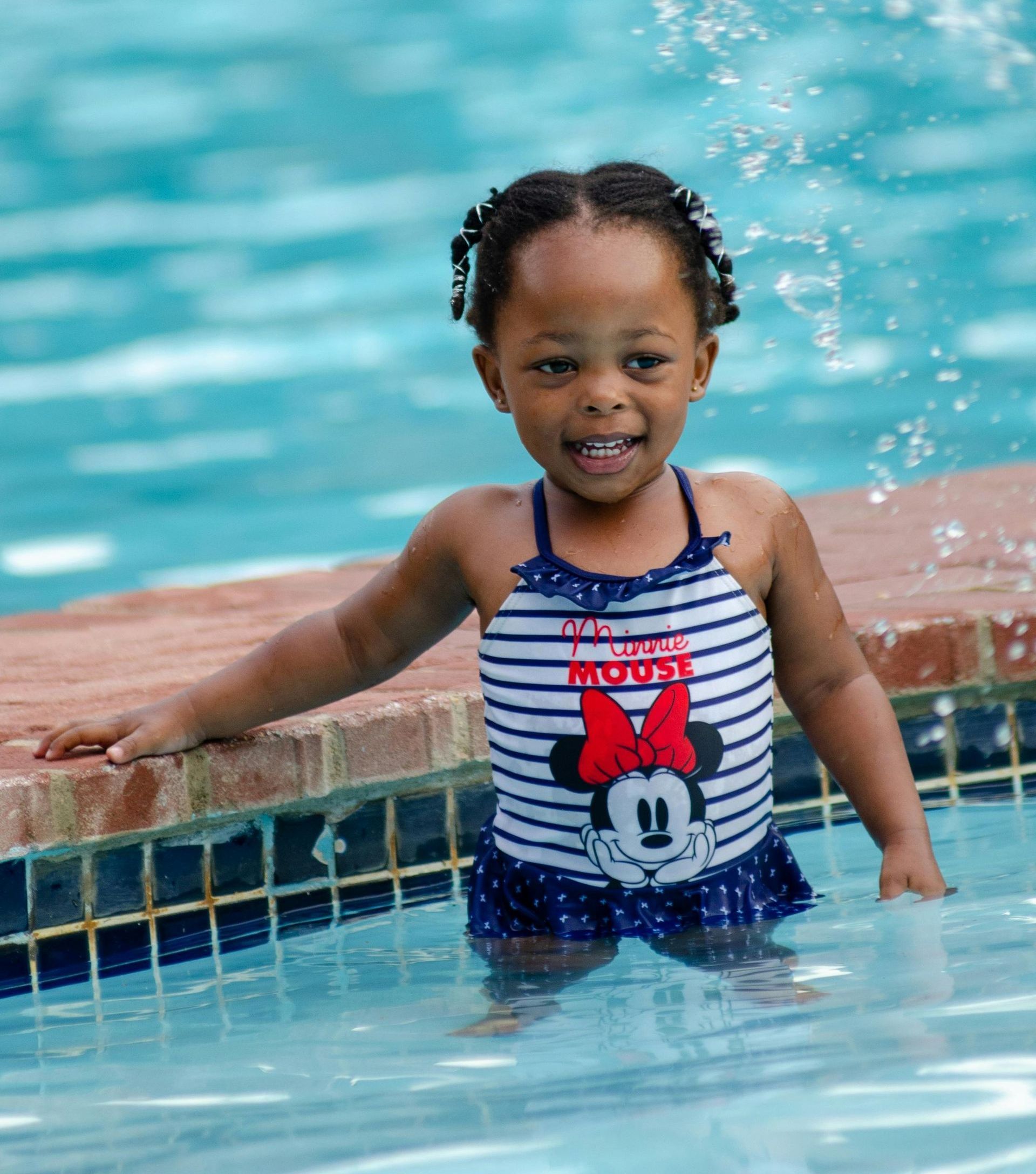 Toddler girl smiling in swimming pool Virginia Beach