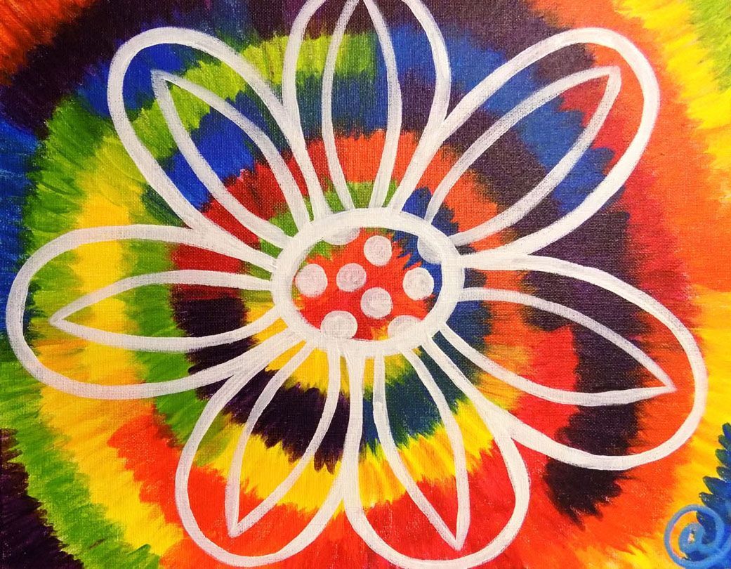 A colorful tie dye background with a white flower in the center