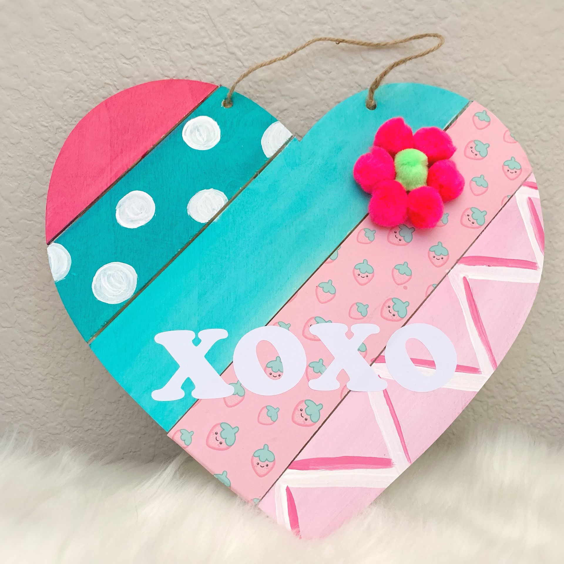A wooden heart with the word xoxo written on it
