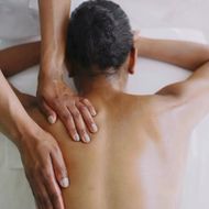 A woman is getting a massage on her back.