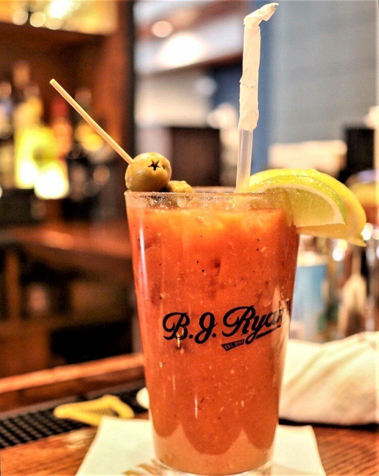 A Bloody Mary cocktail in a glass marked 