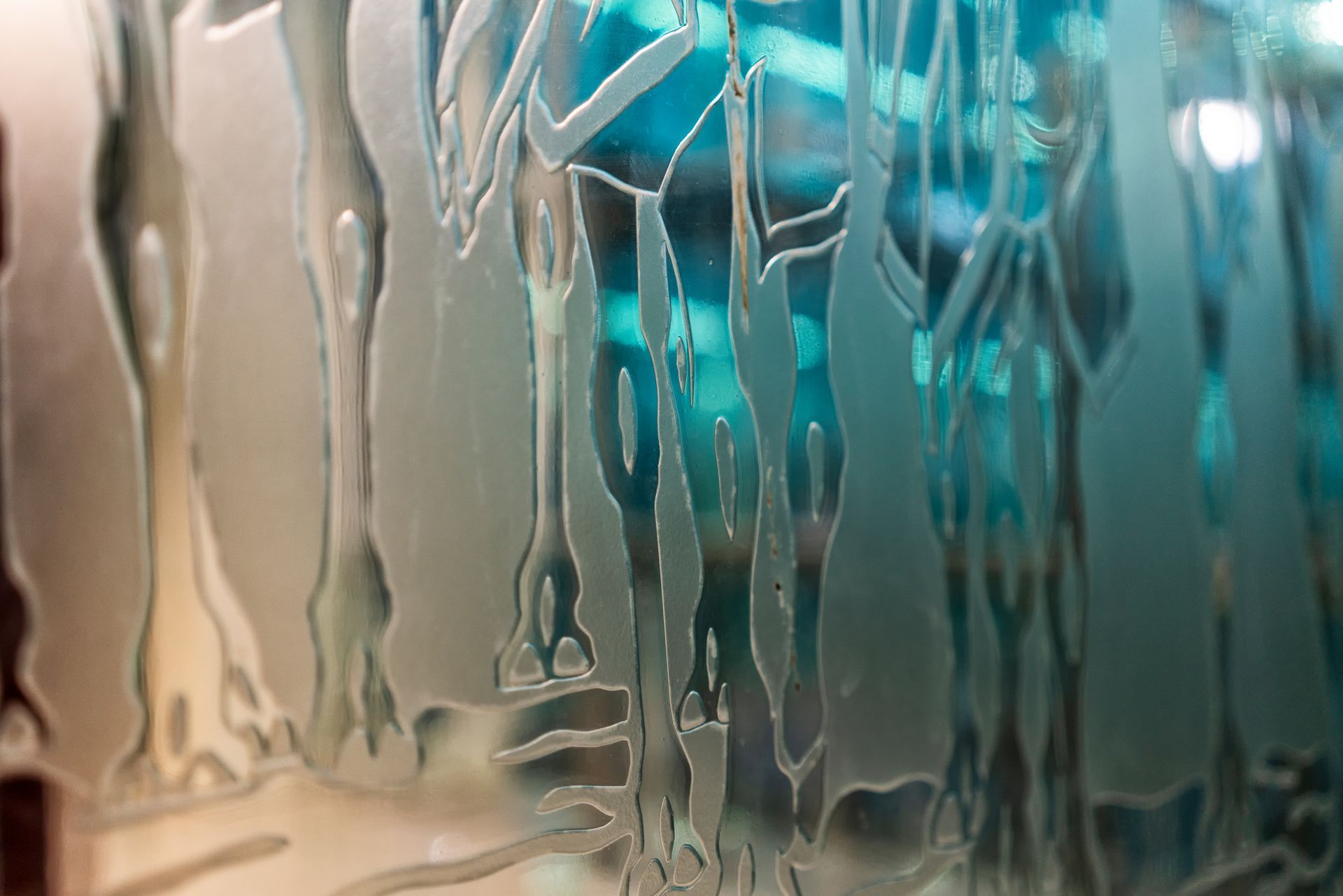 Close-up of a beautifully customised glass panel with engravings.