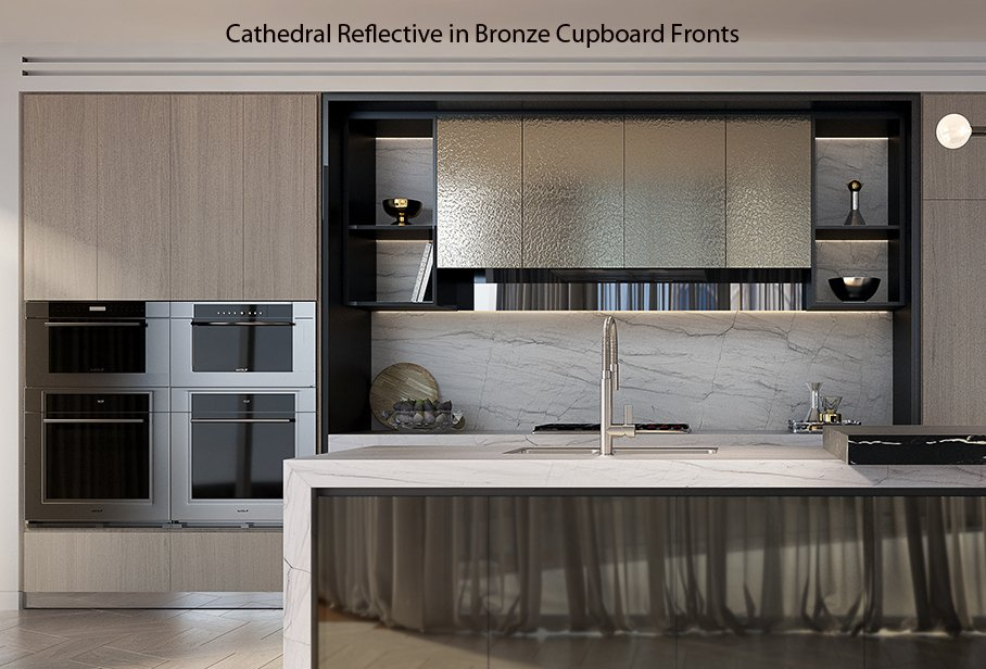 Modern kitchen with bronze cabinet fronts, built-in ovens, and a large island under pendant lights