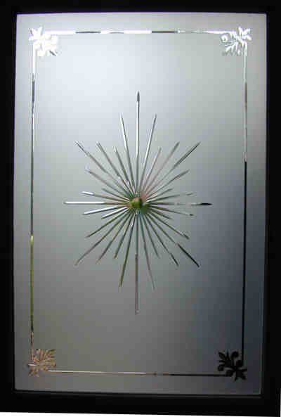 Frosted glass panel with a central starburst design and decorative corner motifs