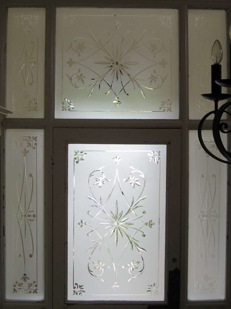 Decorative frosted glass door panel with etched floral and starburst patterns