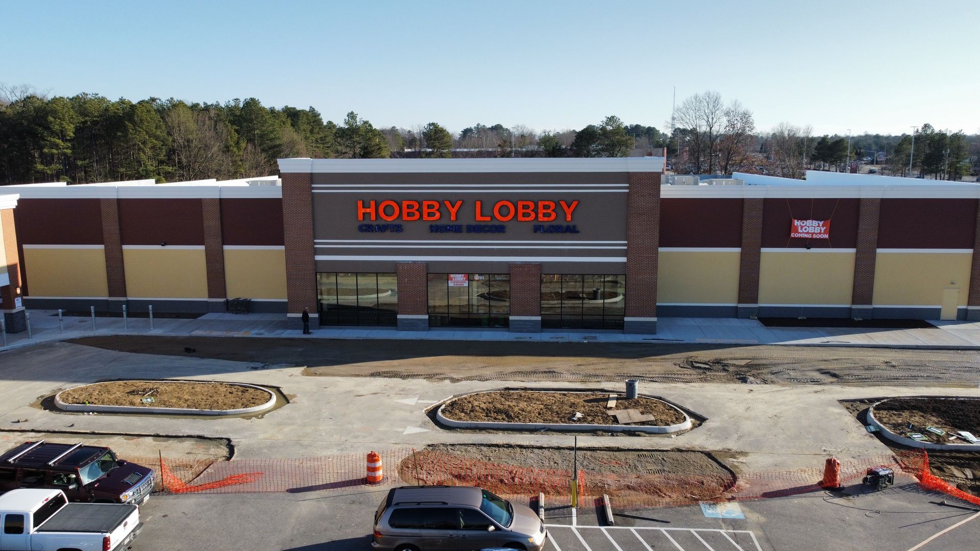 Hobby Lobby store exterior with orange lettering and brick facade, construction in progress.