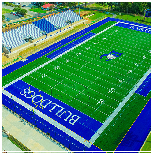 Aerial view of a green Buffalo football field with blue end zones and bleachers beside it.