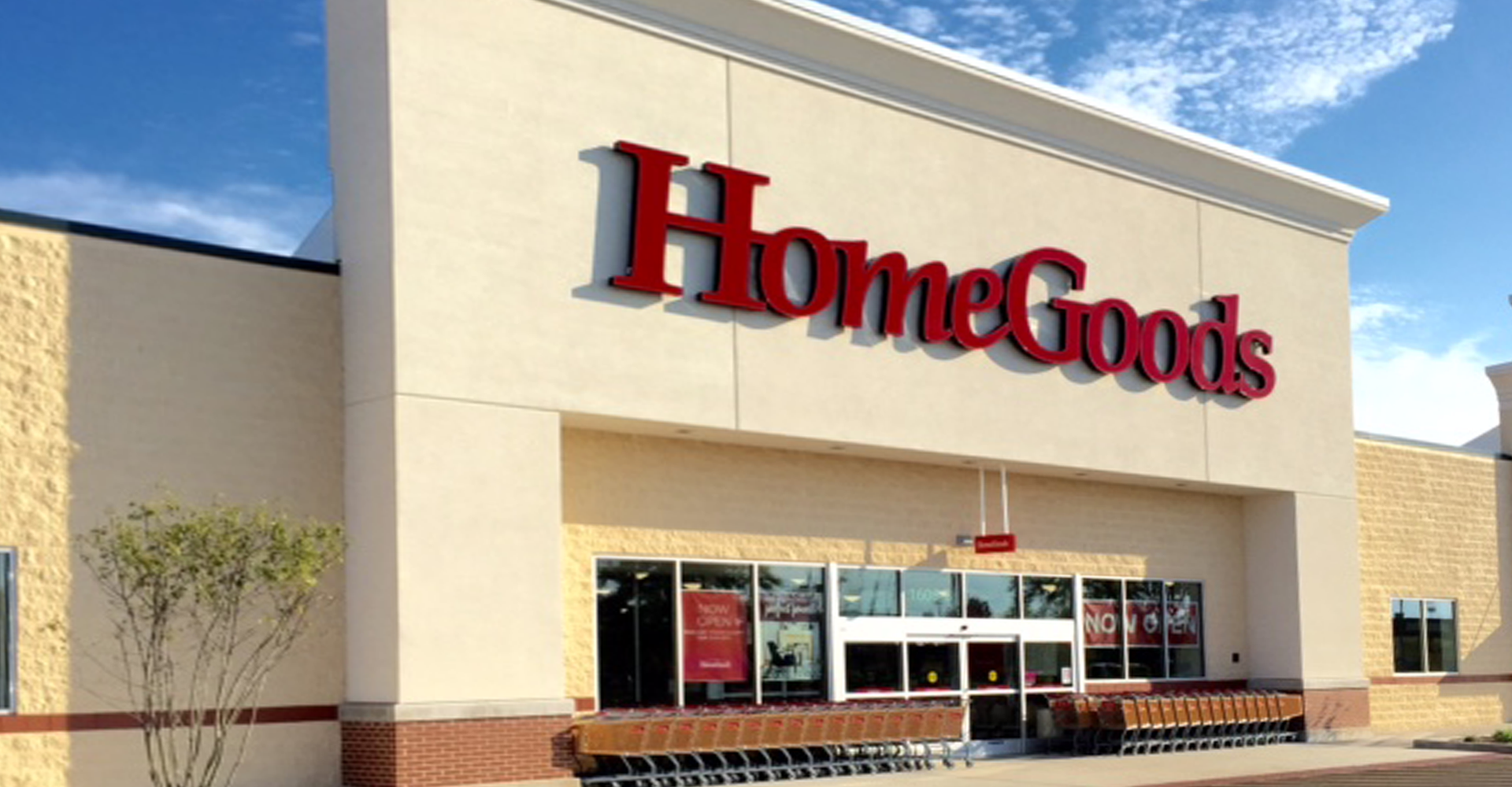 HomeGoods store exterior with red sign against beige building, clear sky.