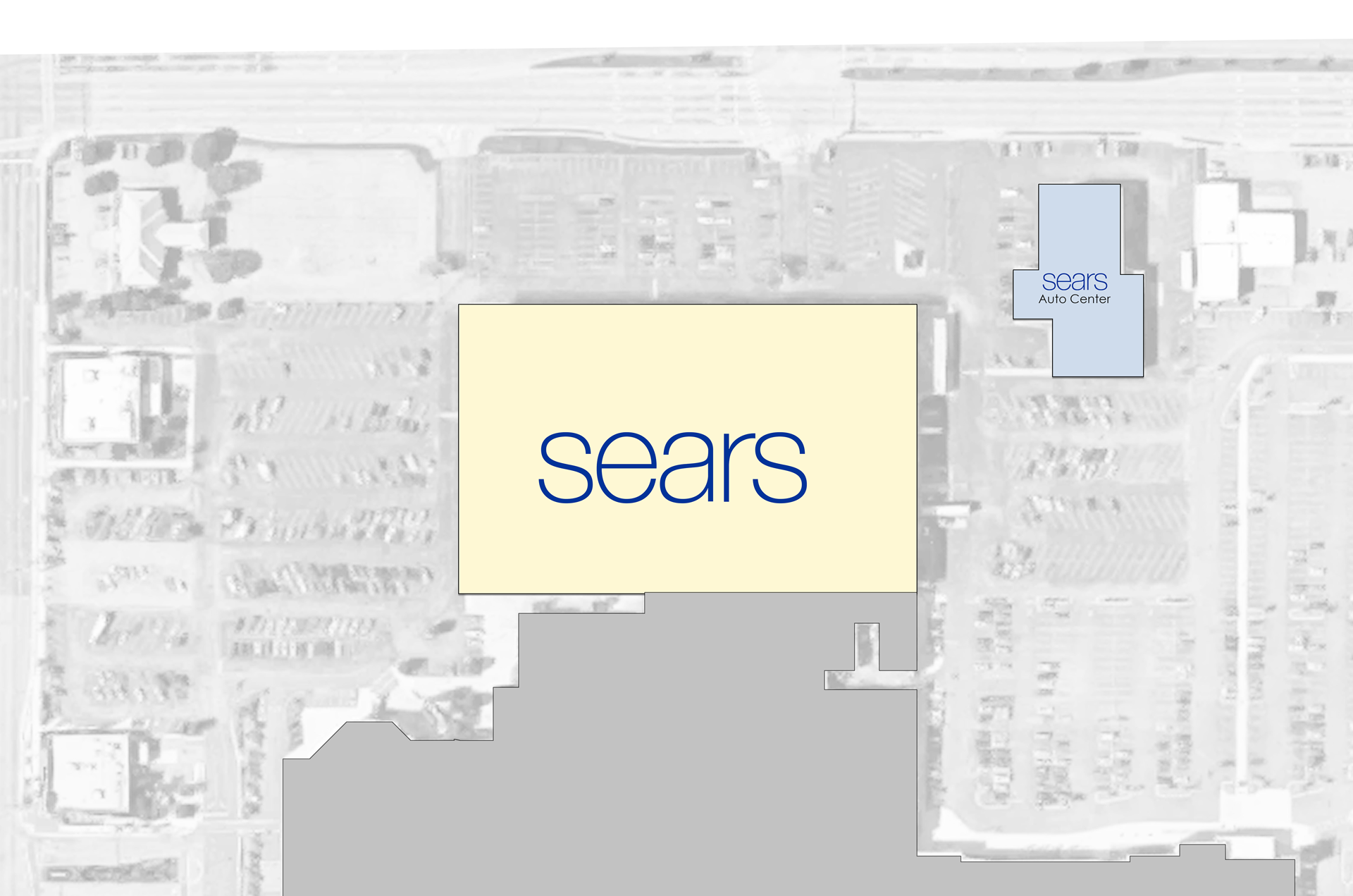 Overhead view of a Sears store with parking lot, and another smaller building to the east.