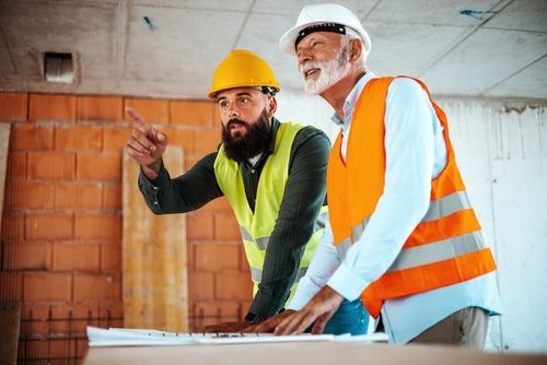 Two construction workers in hard hats