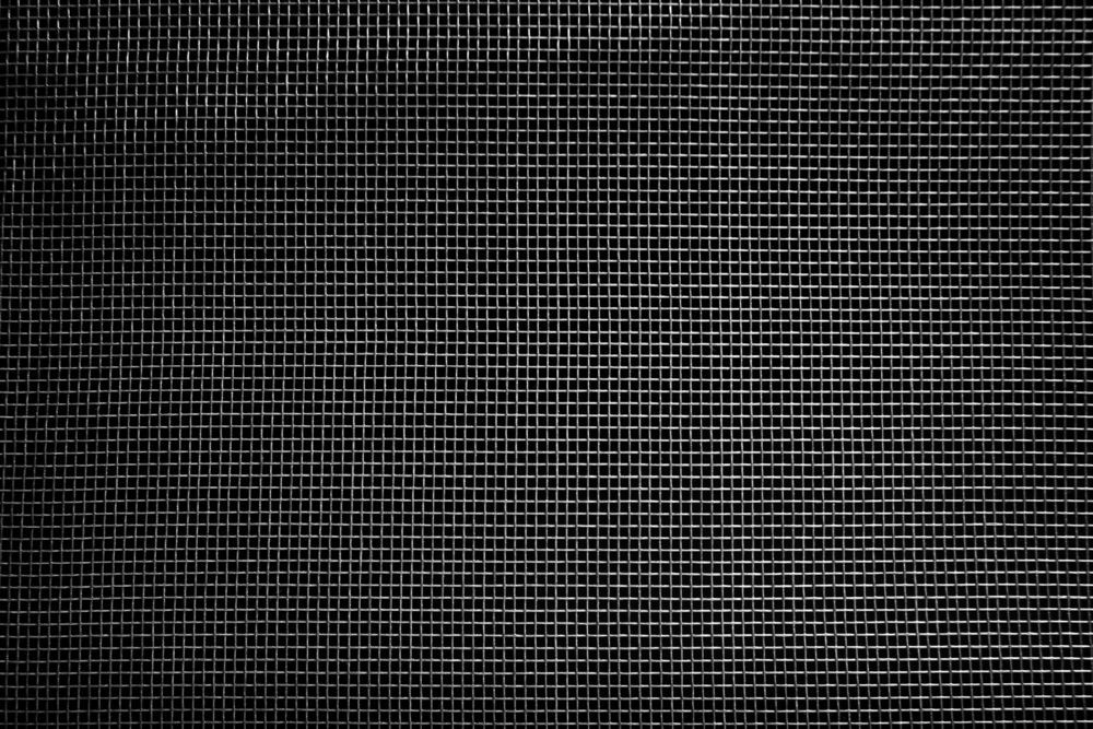 A close up of a black and white grid on a black background.