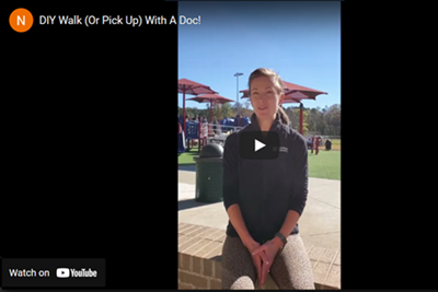Woman in athletic wear sits outside; park in background. Video title:
