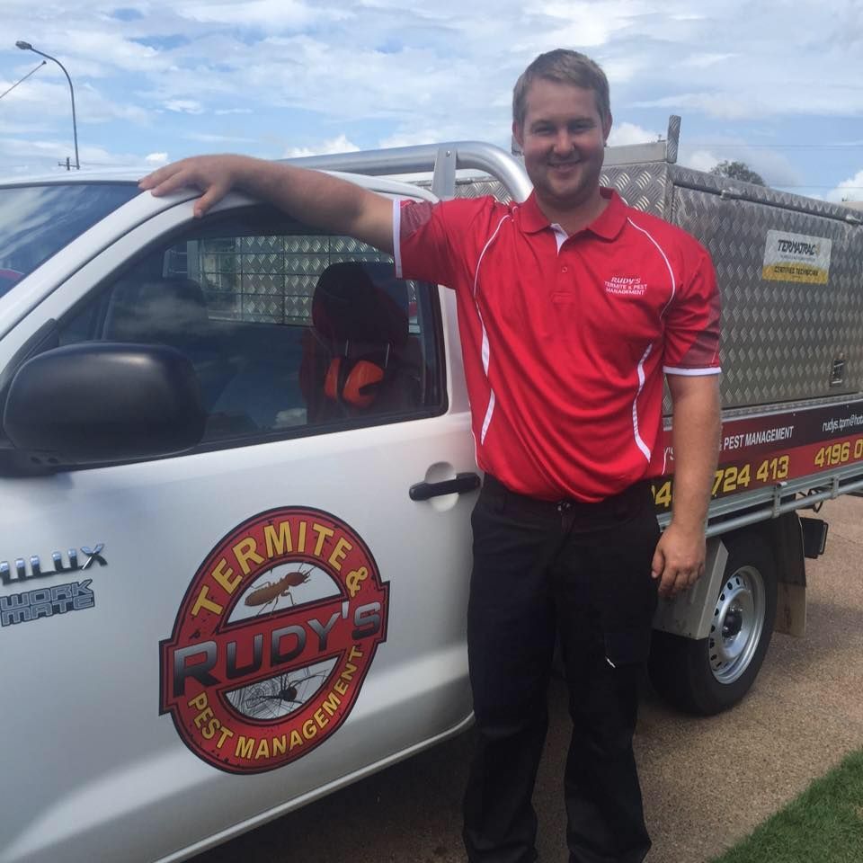 Man Standing Beside a White Utility Truck With a Red Company Logo — Rudy's Carpet Cleaning & Pest Management In Sharon, QLD