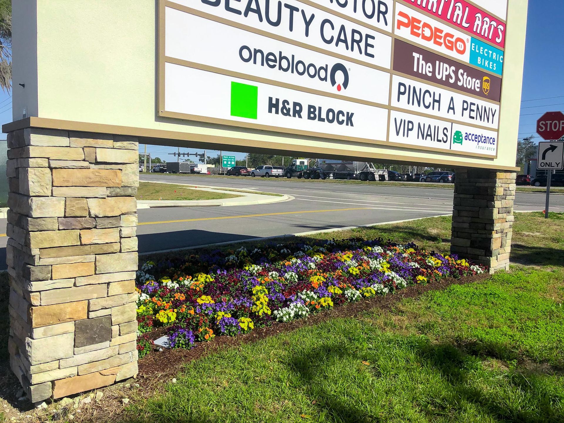 A large billboard with flowers in front of it.