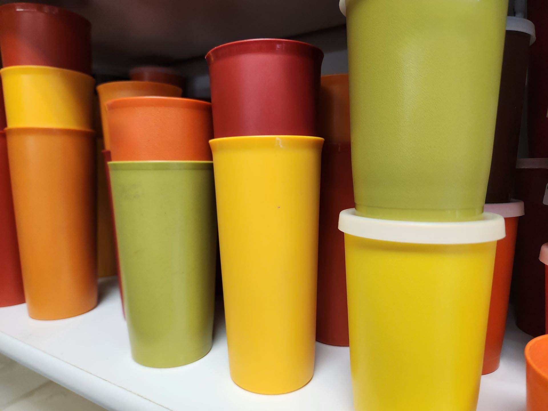 A bunch of different colored plastic cups stacked on top of each other