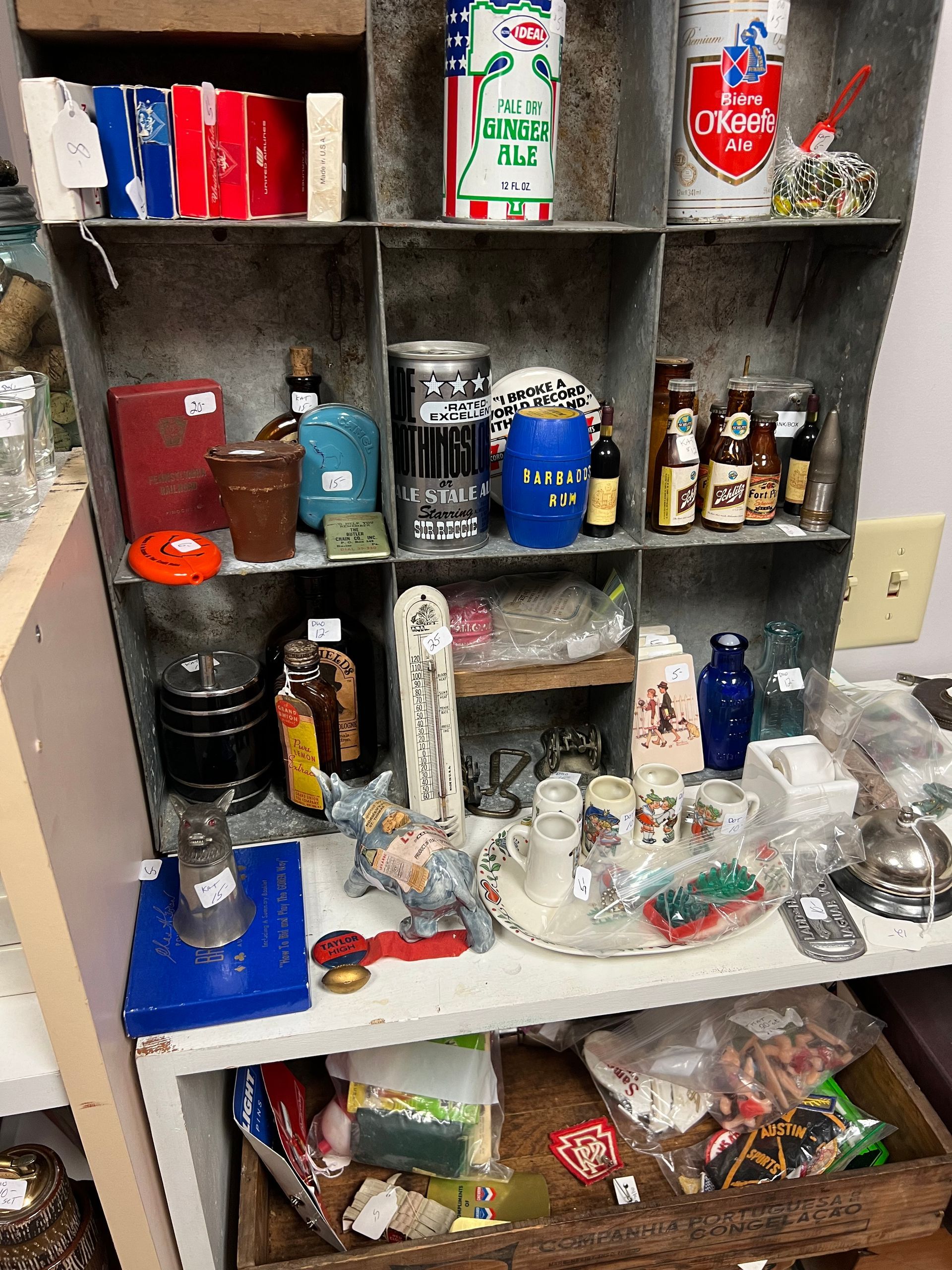 A shelf full of bottles and cans including one that says coca cola