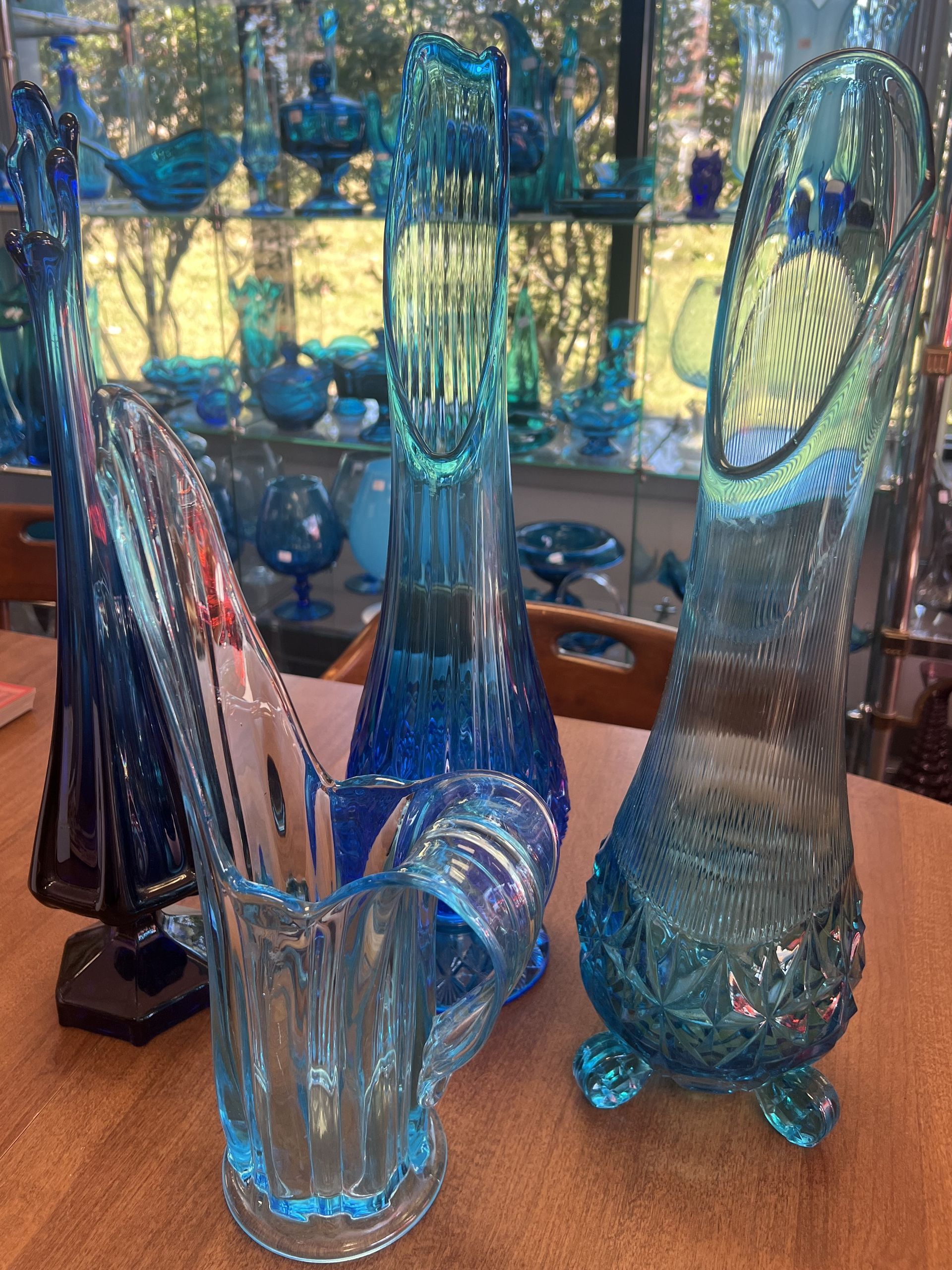Three blue glass vases called swung glass