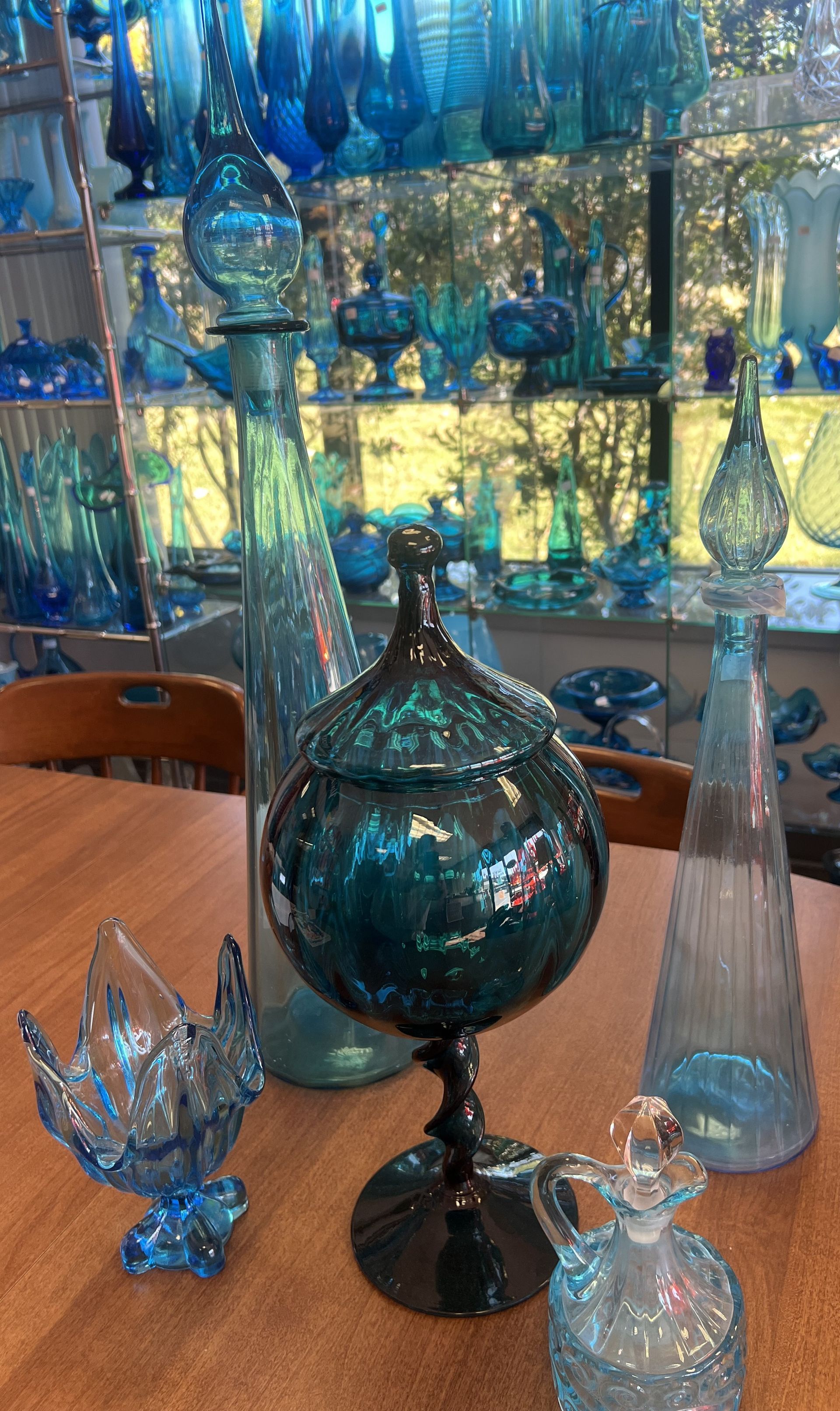 A table with a lot of blue swung vases