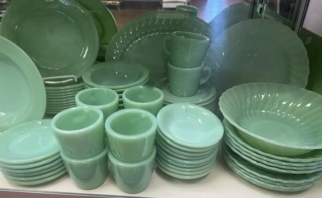 A table topped with plates , bowls , cups and saucers.