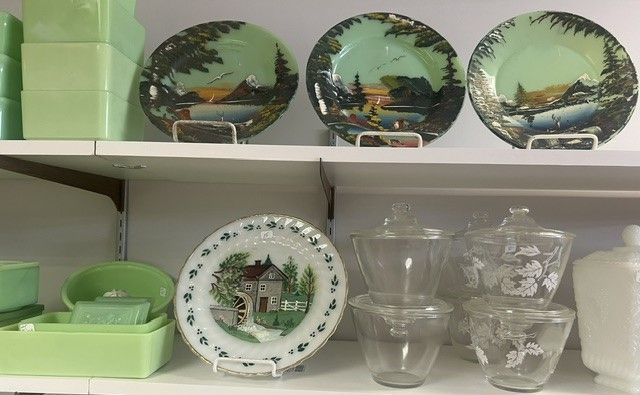 A shelf with plates and bowls on it