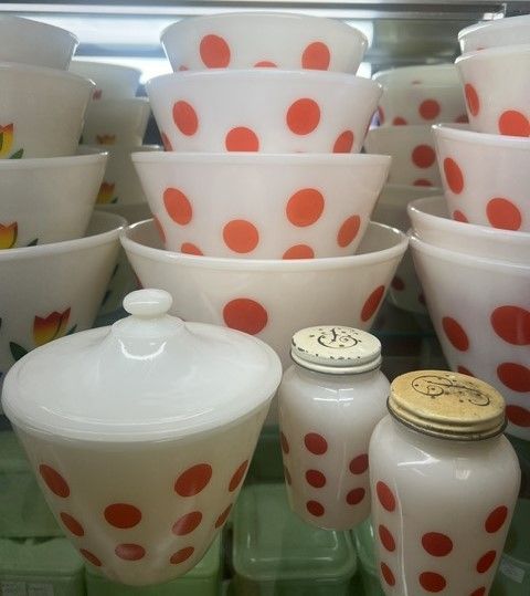 White bowls with red polka dots are stacked on top of each other