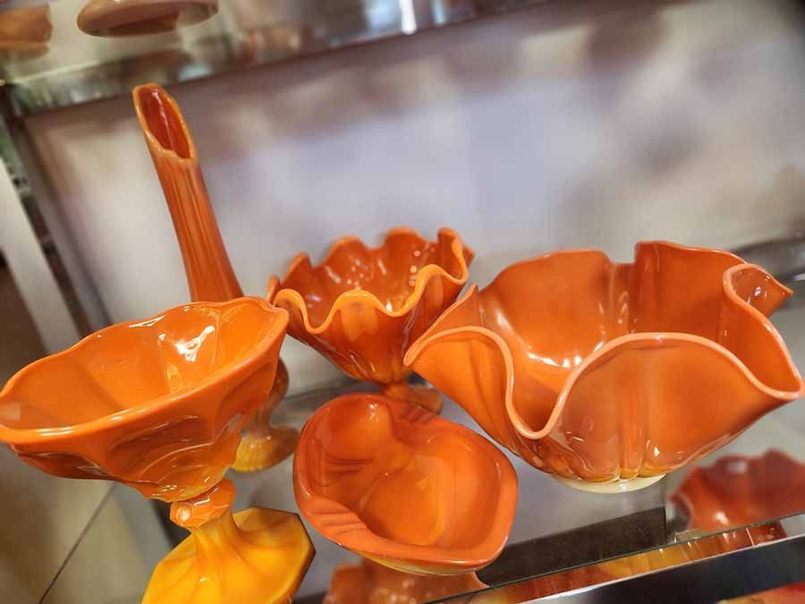 A group of orange bowls are sitting on a table