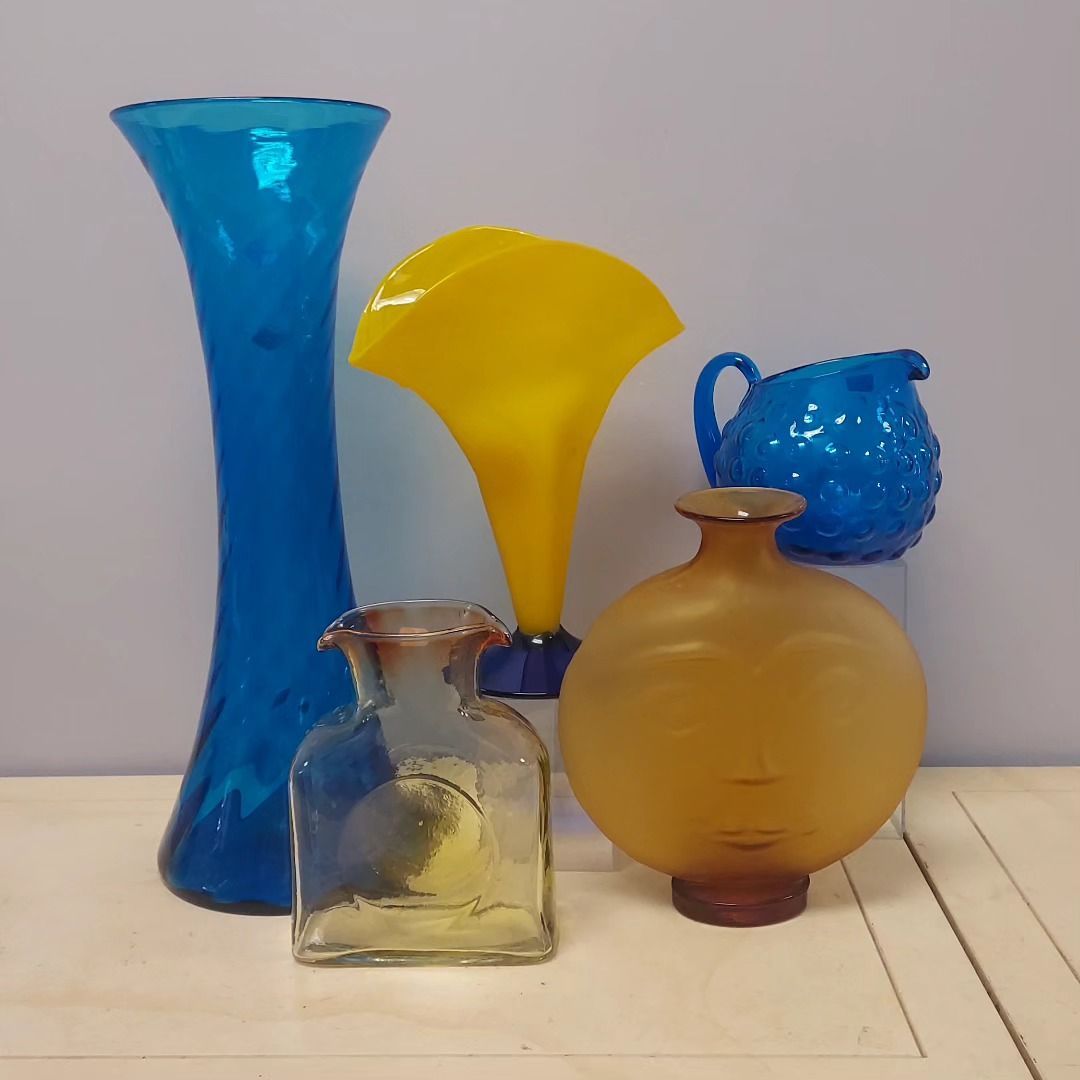 A group of colorful vases are sitting on a table