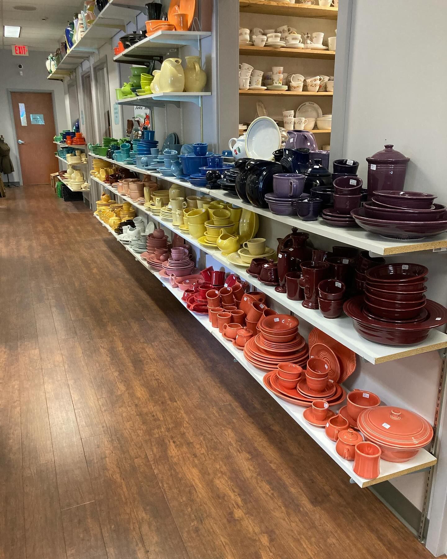 A store filled with lots of colorful pottery on shelves
