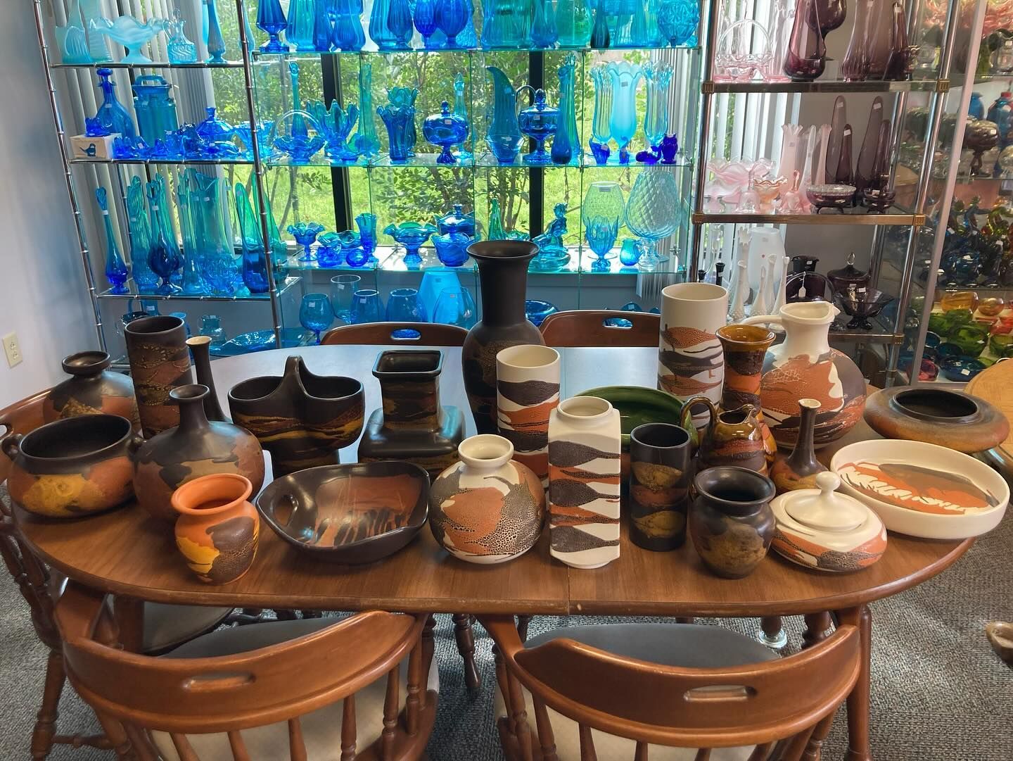 A table with a lot of vases and bowls on it