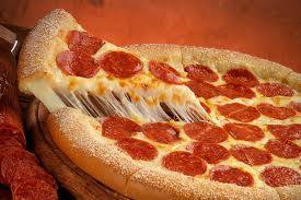 A pepperoni pizza with a slice taken out of it.