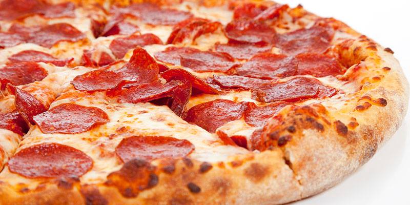 A pepperoni pizza with cheese on a white background.