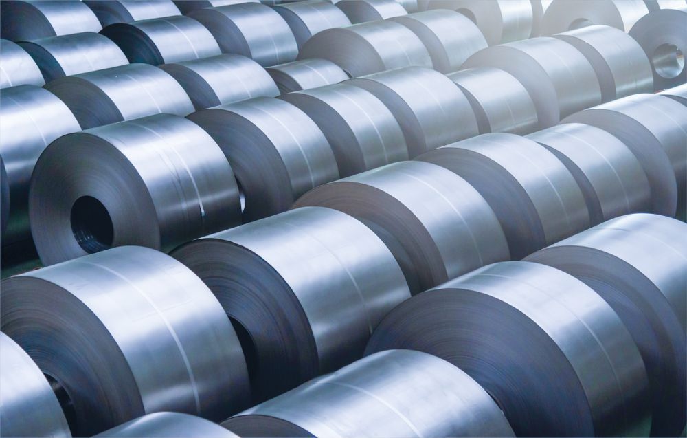 Steel Coils Stacked In A Warehouse, Silver Cylinders — Sheetmetal Improvements & Design in Southport, QLD