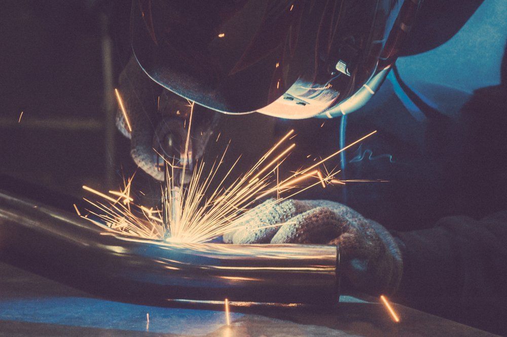 Welder in Protective Gear Welding Metal Pipe — Sheetmetal Improvements & Design in Burleigh Heads, QLD