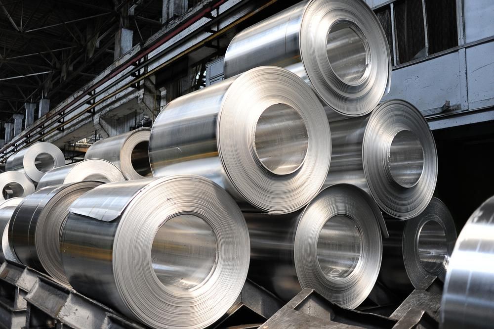 Coils Of Shiny, Rolled Metal Stacked — Sheetmetal Improvements & Design in Molendinar, QLD
