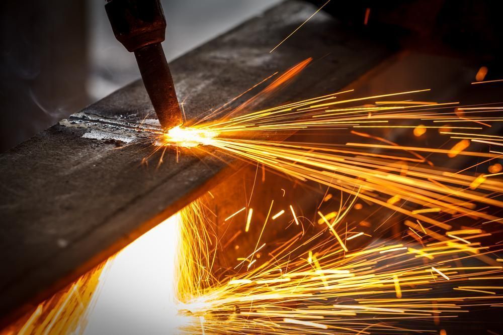 Sparks Fly as A Metal Piece Is Cut — Sheetmetal Improvements & Design in Yatala, QLD