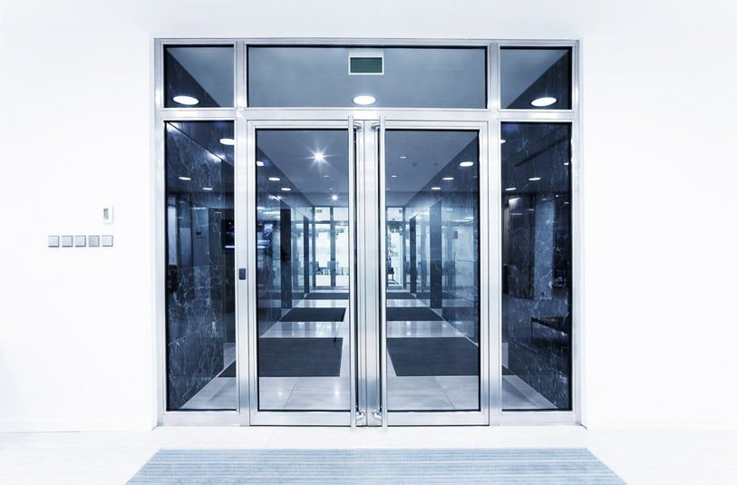 Glass Doors Leading Into a Building Hallway — Sheetmetal Improvements & Design in Burleigh Heads, QLD