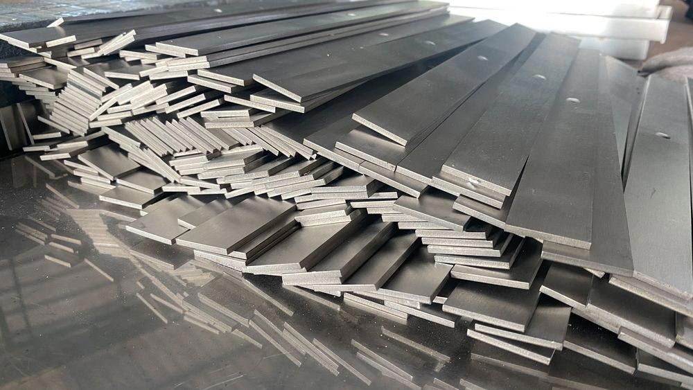 Stacks of Rectangular Metal Bars on a Reflective Surface — Sheetmetal Improvements & Design in Burleigh Heads, QLD