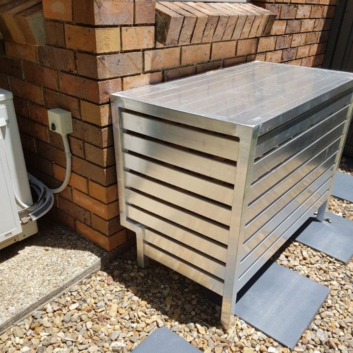 Silver Metal Ac Unit Cover Next To A Brick Wall — Sheetmetal Improvements & Design in Yatala, QLD