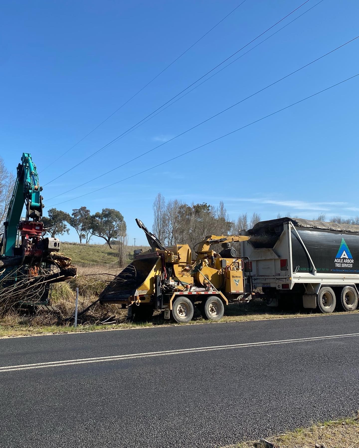 Wood Chipper and Excavator Processing Brush Roadside Under Power Lines — Agile Arbor Pty Limited in Lithgow, NSW