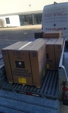 Two boxes are sitting in the back of a truck.