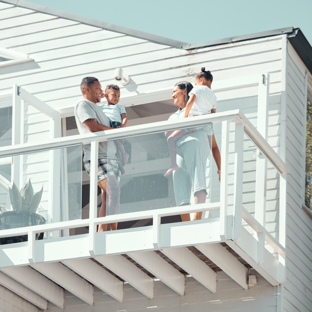 A family standing on a balcony of a house